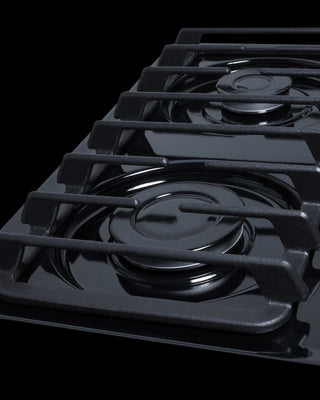 Summit TTL053S cooktop close-up of cast iron grates over sealed burners