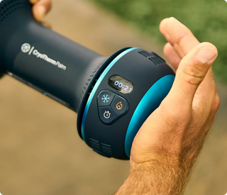 Hand resting on the cooling plate of the Therabody CryoTherm Palm with its timer display lit