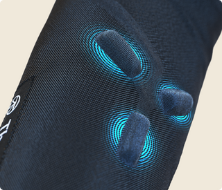 Close-up of the knit fabric on the Therabody RecoveryPulse Arm sleeve with the vibration nodes beneath it