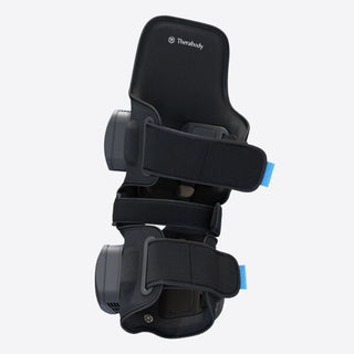 Therabody RecoveryTherm Knee wrap seen at an angle with both straps fastened