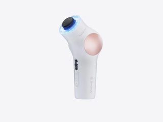 Angled view of the white Therabody TheraFace PRO with a percussive attachment and its light ring glowing blue