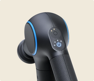 Close-up of the heated attachment and control buttons on the Therabody Theragun Prime Plus