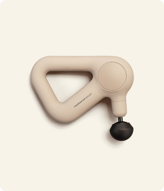 Flat studio view of the sand coloured Therabody Theragun Relief with a ball attachment fitted