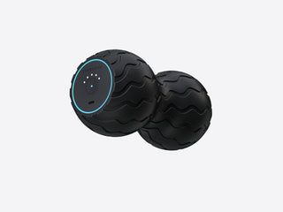Angled view of the Therabody WaveDuo with its lit control ring