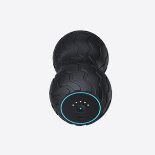 End-on view of the Therabody WaveDuo showing the control face and charging port