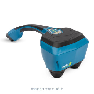Thumper Lithium2 cordless percussion massager in black and teal with rechargeable battery and charging nest.