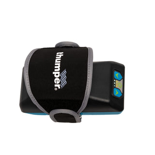 Thumper Lithium1 cordless percussion massager with a wearable glove-style hand strap in black and teal.
