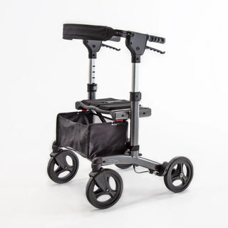 Compact Triumph Mobility Escape Petite rollator with a lightweight aluminum frame, padded seat, adjustable padded backrest, anatomical handgrips, four wheels, and a folding shopping bag beneath the seat.