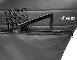 Black padded travel cover for the Triumph Prestige rollator with two front zippered storage pockets, securing buckles, a lifting handle strap, and zipper openings for handle access.