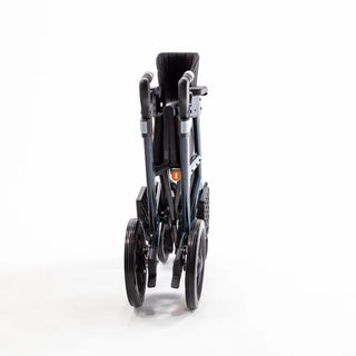Light blue Triumph Prestige all-in-one rollator and transport chair with a black padded seat, padded backrest, ergonomic handgrips, armrests, four wheels, and integrated footrests in transport chair configuration.