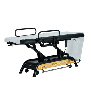 Viva Comfort ADI903-30 Atlas treatment table with exam paper, angled view with handrails