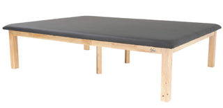 Viva Comfort ADI996-05-BLK rehab mat table with black top and natural wood legs, angled view