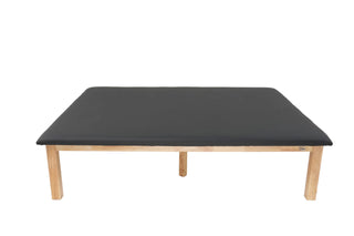 Viva Comfort ADI996-05-BLK rehab mat table, end view of black top and wood frame