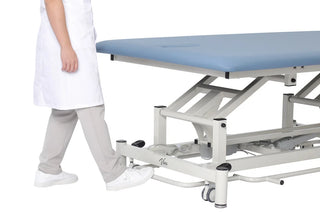 Viva Comfort ADI903-02 Elite hi-lo therapy table with a clinician pressing the foot bar
