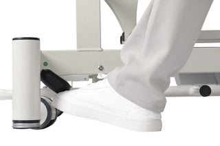 Viva Comfort ADI903-02 Elite hi-lo therapy table close-up of foot pressing the caster release