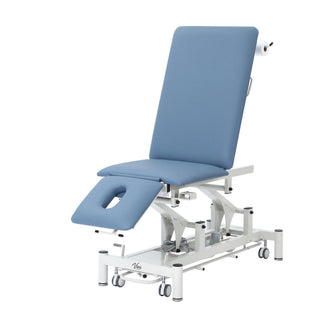 Viva Comfort ADI903-01 Elite hi-lo exam table, angled view with leg section lowered
