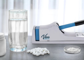 Viva Comfort ADIME950-01 close view of pill crusher next to a water glass and crushed powder dish