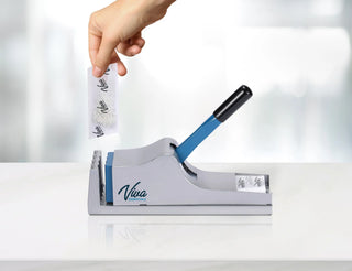 Viva Comfort ADIME950-01 hand placing a pill pouch into the crusher on a white counter