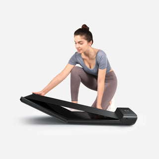 Woman unfolding the WalkingPad A1 Pro treadmill on the floor