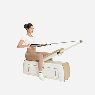 Woman performing a seated row on the WalkingPad B2 Pilates bench