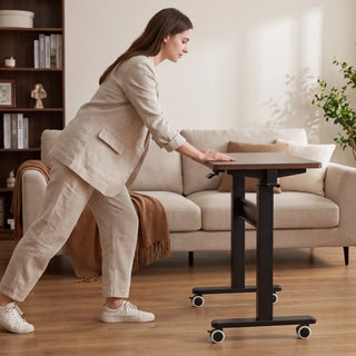 Woman pushing the WalkingPad ETD3 standing desk across a living room