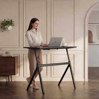 Woman working at the WalkingPad ETD6 standing desk in a bright office