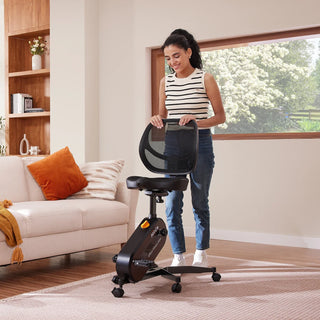Woman rolling the WalkingPad FC1 office bike chair across a living room