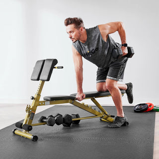 Man performing a dumbbell row beside the WalkingPad MATE-WB1 Roman chair