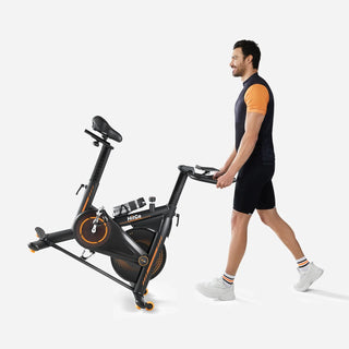 Man tilting the WalkingPad MRB1 exercise bike onto its transport wheels