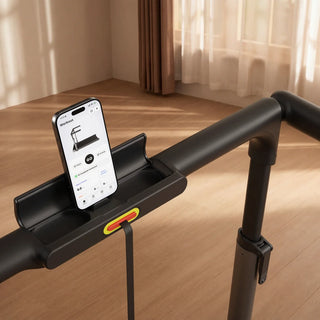 Phone resting in the holder on the WalkingPad MX3 handrail