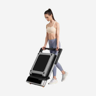 Woman wheeling the folded WalkingPad MX3 treadmill across the floor