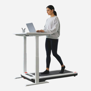Woman walking on the WalkingPad Massage Step treadmill at a standing desk