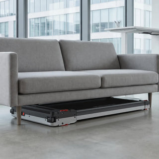 WalkingPad Massage Step treadmill stored under a sofa