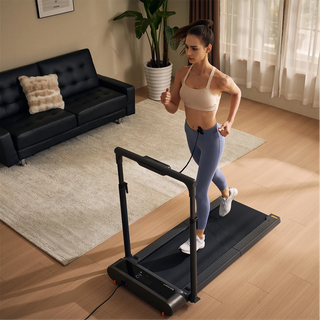 Woman running on the WalkingPad R3 Hybrid treadmill in a living room