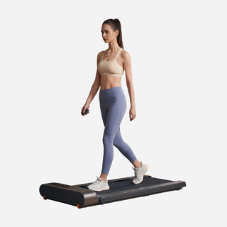 Woman walking on the WalkingPad R3 treadmill