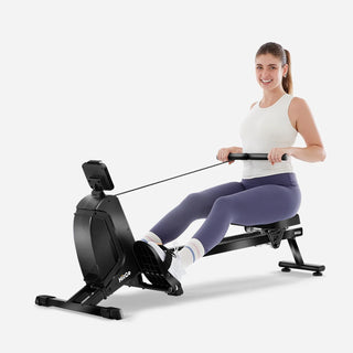 Woman rowing on the WalkingPad RM1 magnetic rowing machine