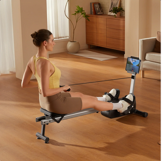 Woman rowing on the WalkingPad RW001 with a tablet showing a workout