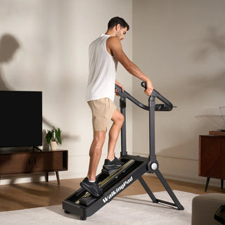 Man climbing on the WalkingPad Stair Stepper in front of a television