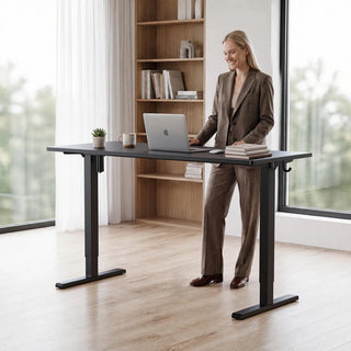 Woman standing at the WalkingPad two-piece standing desk beside a tall window