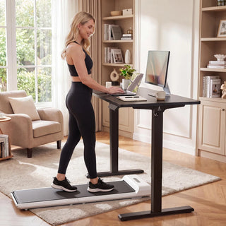 Woman walking on a treadmill while working at the WalkingPad two-piece standing desk