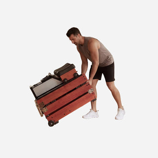 Man tilting the folded WalkingPad WM10 rowing machine to wheel it away