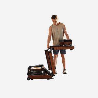 Man wheeling the folded WalkingPad WR3L water rowing machine