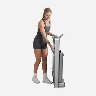 Woman tilting the folded WalkingPad X214 treadmill to wheel it away