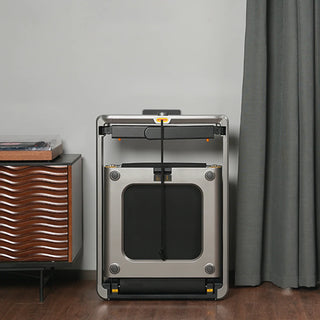 WalkingPad X214 treadmill folded and stored upright beside a cabinet