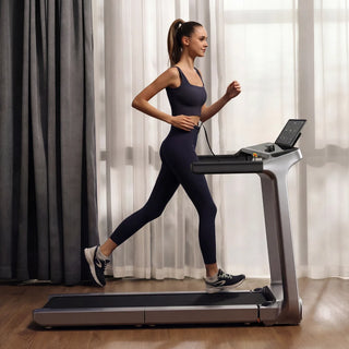Woman running on the WalkingPad X218 treadmill in a room with curtains