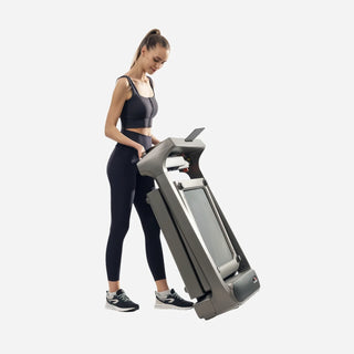 Woman tilting the folded WalkingPad X218 treadmill to wheel it away