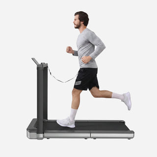Man running on the WalkingPad X25 treadmill with a tablet on the frame