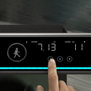 Finger pressing the touch controls on the WalkingPad X25 Plus console
