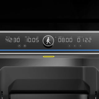 WalkingPad X25 Plus console lit up with its light bar in a dark room