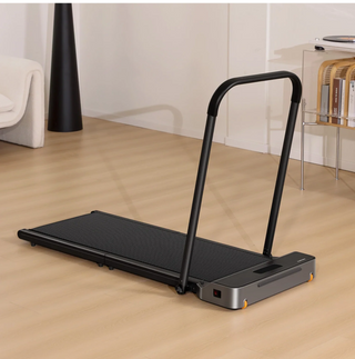 WalkingPad Z1R treadmill open with the handrail up in a living room